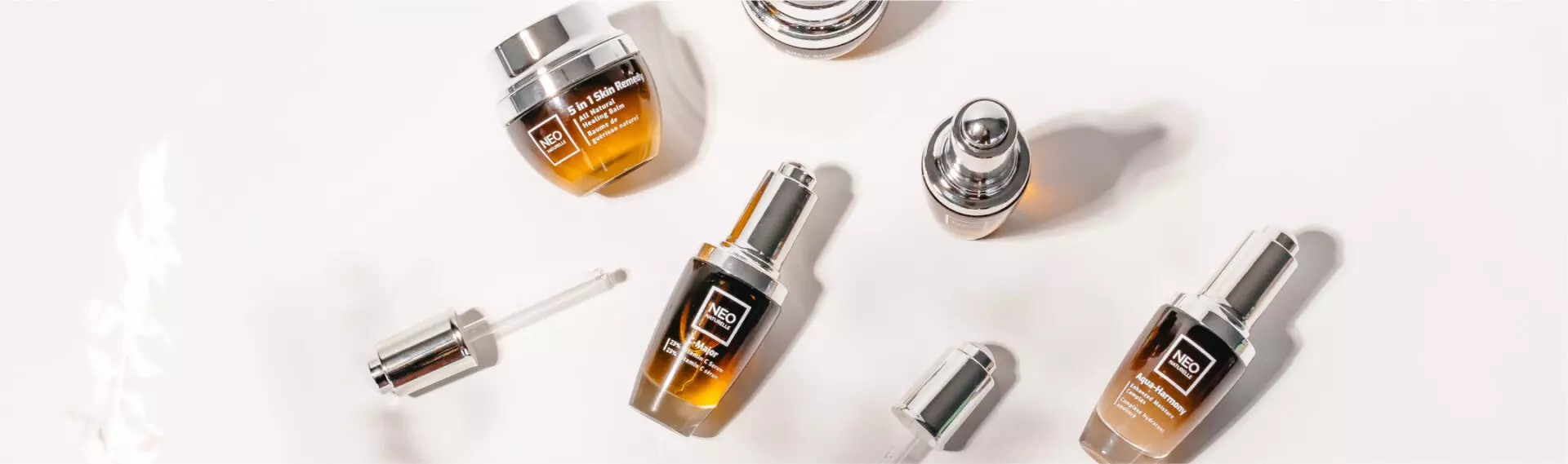 Glass serum bottles with droppers on white background, featuring C-Major Vitamin C serum for menopausal skincare